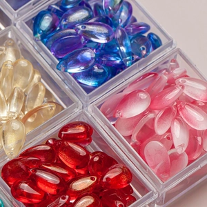 Close-up of colorful teardrop glass petals with pre-drilled holes for DIY hairpins