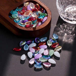 Macro view of teardrop glass beads in various colors for DIY jewelry making and crafts