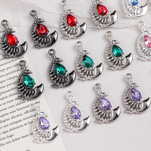 Macro detail of alloy fishbone charms with pear-cut crystals in silver and gunblack finish