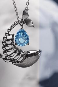 Macro detail of alloy whale bone pendant with inlaid blue cubic zirconia gemstone