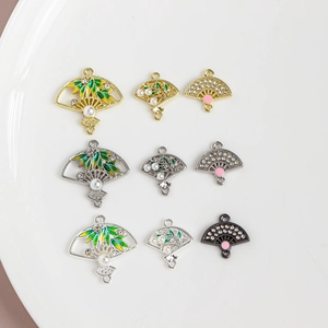 Detailed view of Chinese fan pendants with bamboo leaves and floral enamel inlays