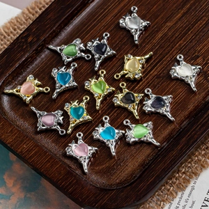 Detail of colorful cross and heart pendants in cat-eye stone on a rustic wooden tray