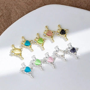 Detail of heart-shaped cat-eye stone pendants with sparkling rhinestones in a ceramic dish