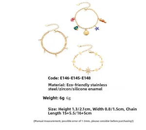 Detailansicht von drei goldenen Edelstahl-Armbändern mit Meeresmotiven und Zirkonia