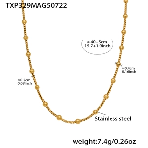 Detail of a minimalist gold bead stainless steel necklace with adjustable extender chain