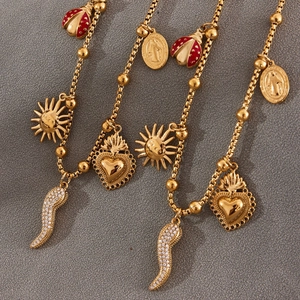 Gold plated bead chain necklace with red enamel ladybug and religious heart charms