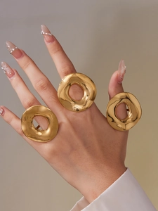Detailed view of polished 18k gold plated stainless steel irregular curved ring