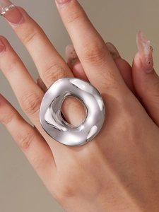 Detailed view of irregular hollow round ring in high-polished 18k gold plated finish