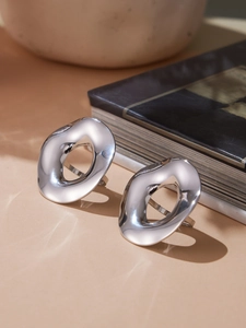 Macro detail of silver flowing curved surface with mirror finish on irregular earring