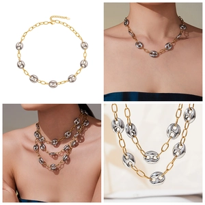Macro view of gold and silver mixed chain necklace with lobster clasp and extension
