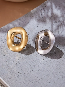Close-up of irregular curved disc rings in polished 18k gold and silver stainless steel