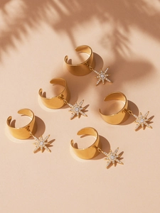 Macro shot of 18k gold plated stainless steel wide band rings with star charms