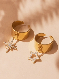 Close-up of gold star and octagon pendants on adjustable wide bands with zircon stones