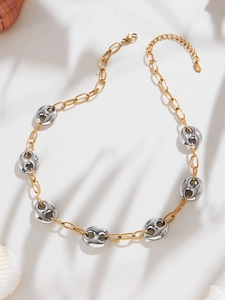 Detail of two-tone stainless steel pig nose chain necklace with lobster clasp and shell