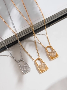 Dettaglio ravvicinato della collana con lucchetto a cuore in oro e argento con zirconi