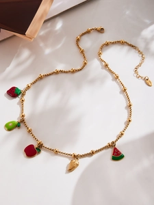 Detail of gold beaded chain necklace with colorful enamel fruit charms and lobster clasp