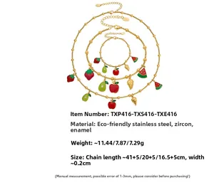 Detail of gold stainless steel fruit jewelry set with strawberry and watermelon charms