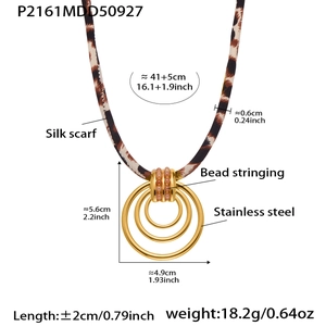 Detailed view of leopard print silk scarf necklace with golden stainless steel rings