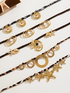 Detail of bohemian necklaces with leopard print fabric and golden starfish shell charms