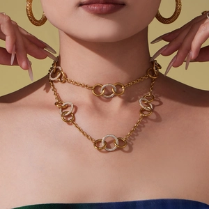 Élégant collier à anneaux entrelacés dorés avec incrustations de zircons étincelants.