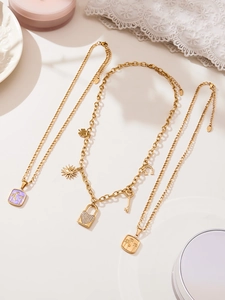 Dettaglio di collane placcate in oro 18k con ciondoli a lucchetto a cuore e zirconi lucidi