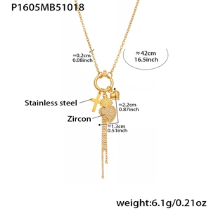 Detail einer goldenen Edelstahlkette mit Zirkon-Herz- und Kreuzanhängern sowie Quasten