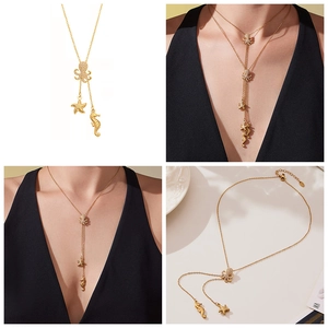 Detail showing the gold octopus starfish pendant necklace with cubic zirconia on a Y-chain