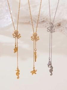 Macro detail of nautical octopus and starfish pendant necklace with zircon stones