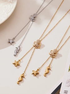 Detail of octopus and starfish pendants with micro-set zircons on gold and silver necklaces