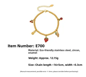 Detail of 18k gold plated stainless steel bracelet with fruit charms and zircons