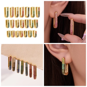 Close-up of U-shaped gold plated earrings set with multi-colored gradient cubic zirconia
