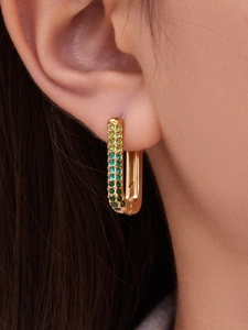 Detail of 18k gold plated U-shaped earring with gradient green pavé set cubic zirconia