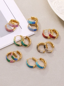 Detail of colorful cubic zirconia hoop earrings with 18k gold plating on gray background