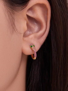 Detail of 18k gold snake earring with pink micro-pave crystals and green gemstone eyes