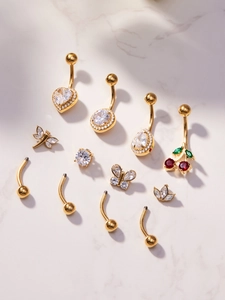 Detailed display of 18k gold plated belly rings with 5A zircon hearts and butterfly charms