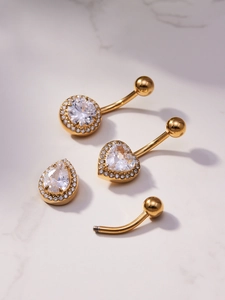 Detailed set of gold belly rings featuring round, heart, and teardrop zircon pendants