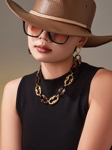 Detail of vintage gold-tone necklace and earrings set with tortoiseshell resin links