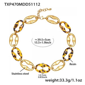 Detail of vintage gold stainless steel chain necklace with leopard resin links and clasp