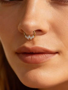 Macro shot of gold titanium nose ring featuring five marquise-cut 5A zircon stones