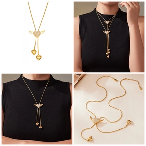 Detailed views of gold heart wing tassel necklace featuring zirconia inlay and Y-chain style