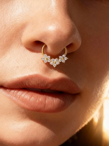 Detailed close-up of a gold titanium nose ring featuring five cubic zirconia flowers