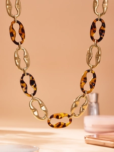 Detail of vintage gold chain necklace with leopard print resin links and metal rings