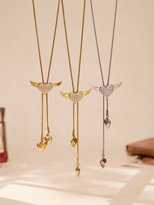 Close-up of heart wing bolo ties with 5A zircon and stainless steel tassels