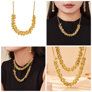 Detail view of 18k gold plated stainless steel necklace and earrings with heart pendants