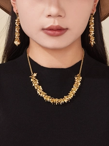 Detailed close-up of 18k gold plated stainless steel heart charm necklace on model
