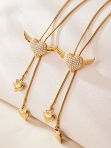 Detailed view of gold wing heart pendant with 5A zircon inlay on adjustable slider chain