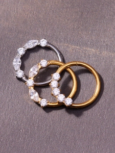 Detailed macro view of titanium segment rings with inlaid cubic zirconia and polished finish