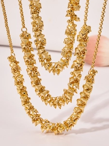 Close-up of triple-layered 18k gold-plated stainless steel necklaces with heart pendants