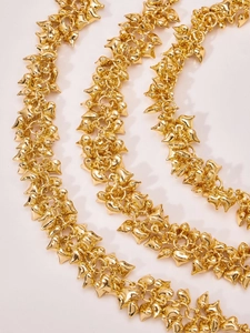 Detail of 18k gold plated stainless steel necklace with multiple hollow heart charms
