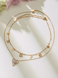 Detail of gold double-layer necklace with multiple heart charms and zircon butterfly motifs